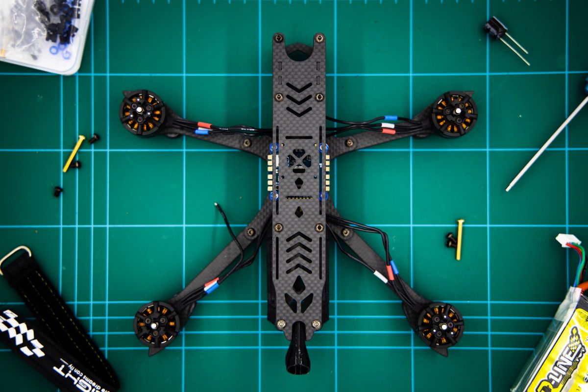 An FPV racing drone being built on a workbench