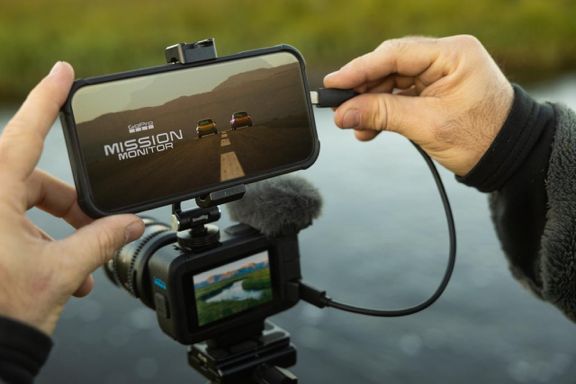 A MISSION 1 Pro on a small rig with a microphone, a phone clipped above it as a monitor